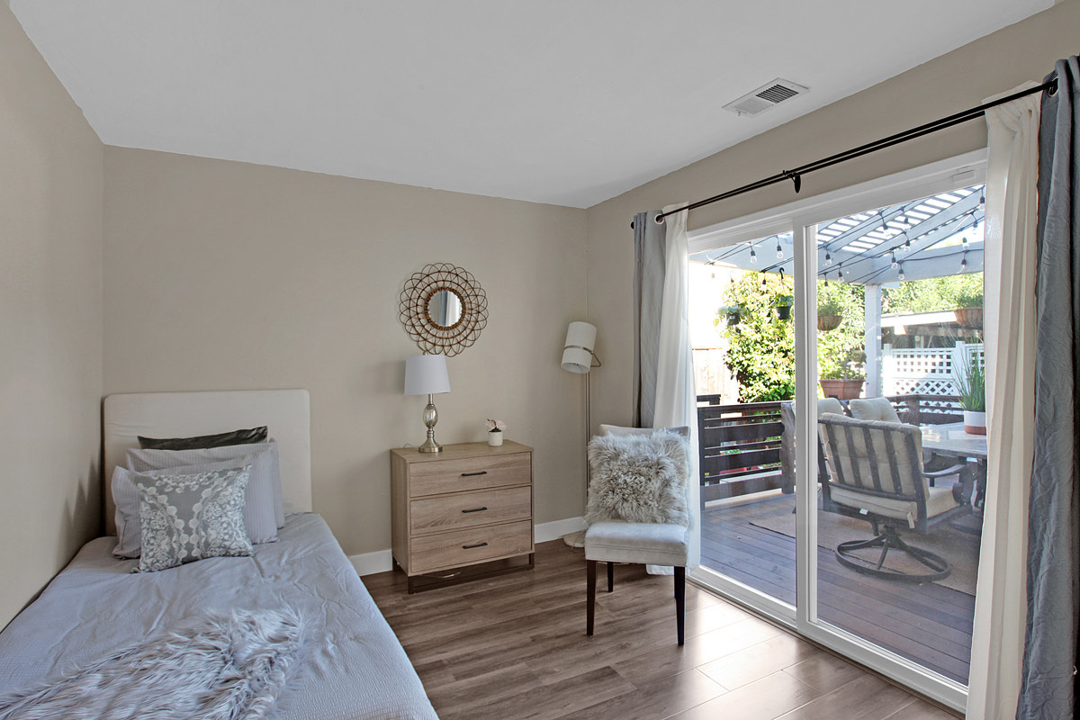 A resident room with its own sliding door onto the patio